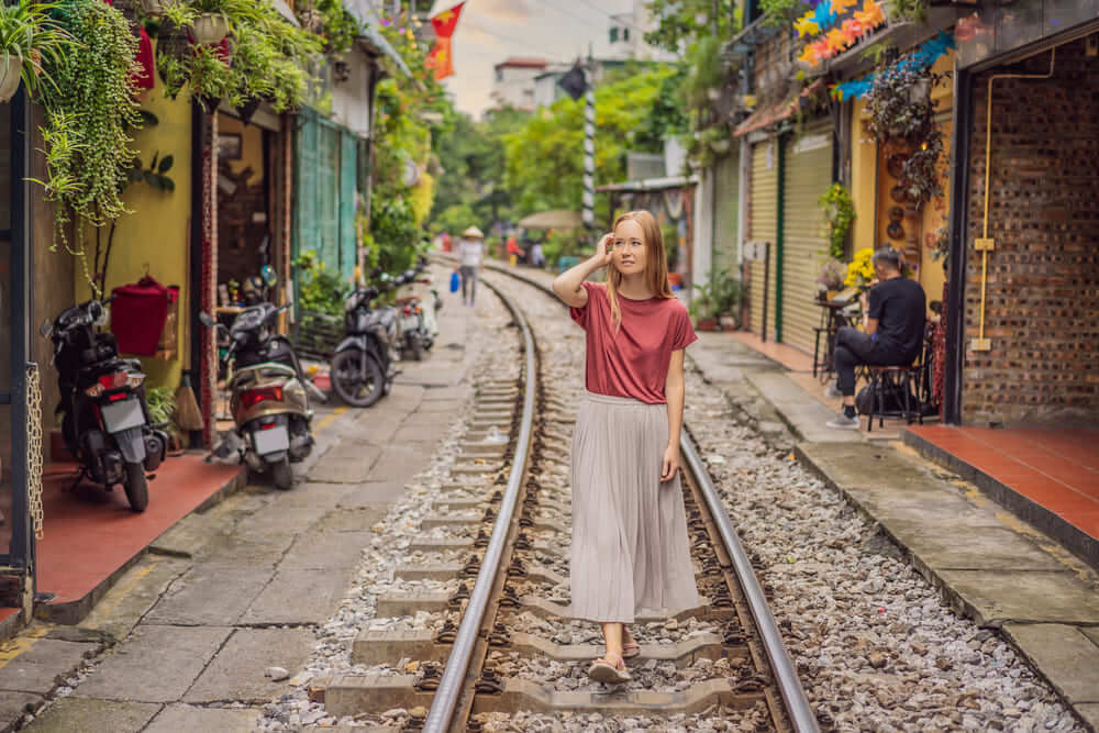 Girl posing on Hanoi Train Street tracks