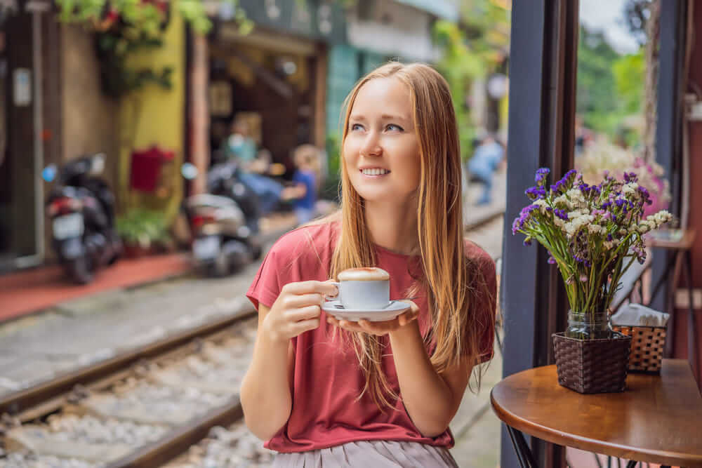Tourist enjoying coffee on Hanoi Train Street