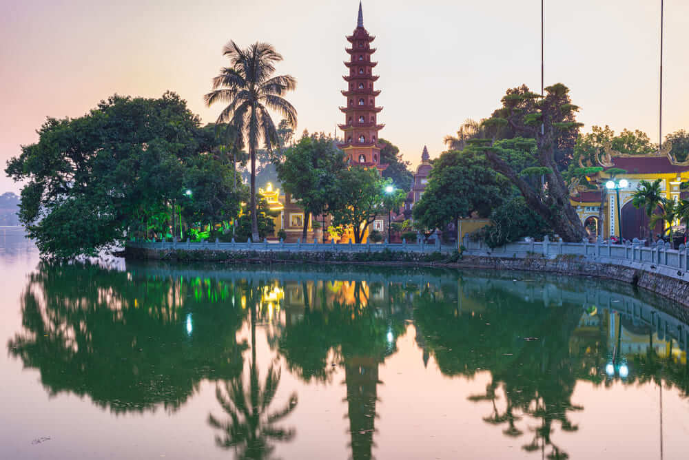 Tran Quoc Pagoda glowing at sunset on West Lake